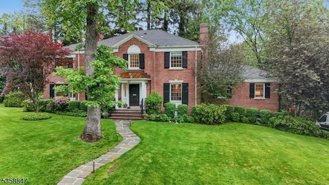 47 Barnsdale Rd, Millburn Twp, NJ 07078 - colonial home with a chimney, a front yard, and brick siding