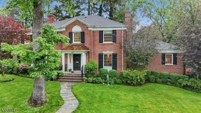 47 Barnsdale Rd, Millburn Twp, NJ 07078 - colonial home featuring a chimney, a front yard, and brick siding