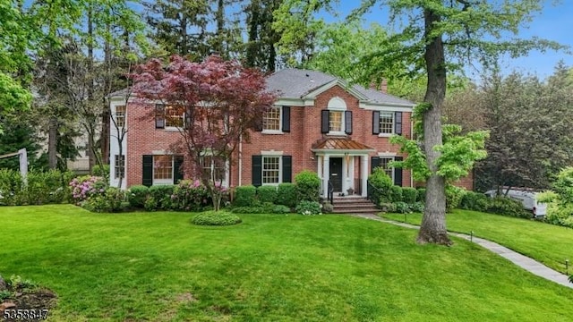 47 Barnsdale Rd, Millburn Twp, NJ 07078 - view of front of property with a front yard, a chimney, and brick siding