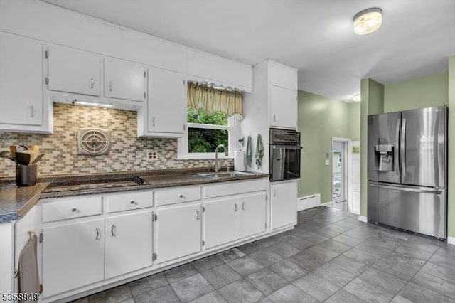 kitchen with black appliances, a sink, backsplash, and white cabinets
