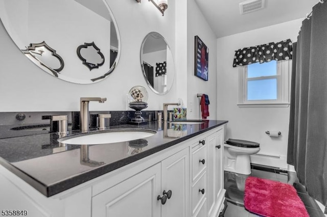 full bathroom featuring toilet, vanity, and tile patterned floors