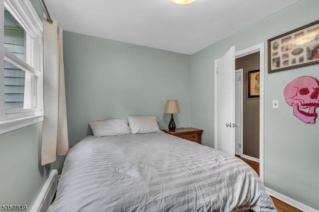 bedroom with wood finished floors and baseboards