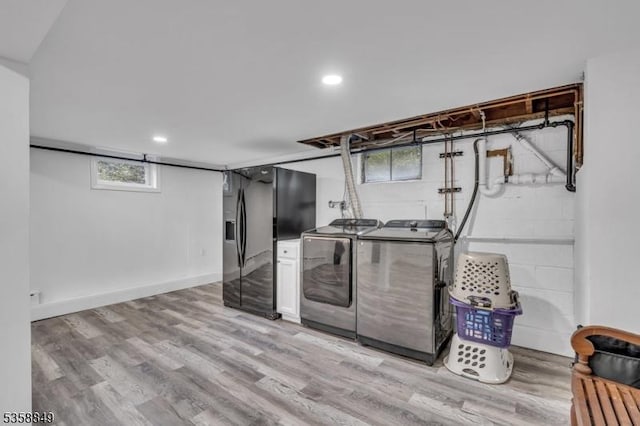 kitchen featuring washing machine and dryer, light wood-style flooring, plenty of natural light, and recessed lighting