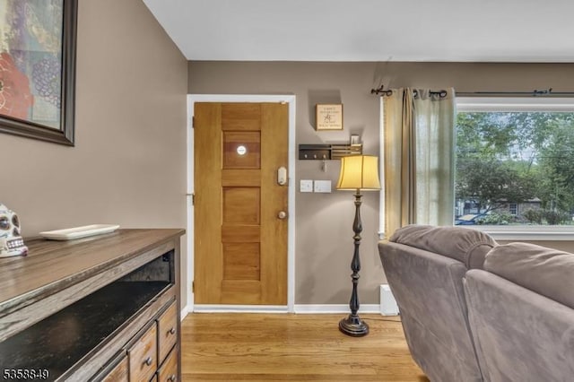 living area with wood finished floors and baseboards