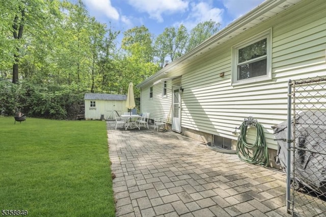 view of patio / terrace featuring a shed, an outdoor structure, and outdoor dining space