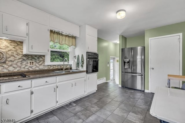 kitchen with black appliances, a sink, tasteful backsplash, dark countertops, and white cabinets
