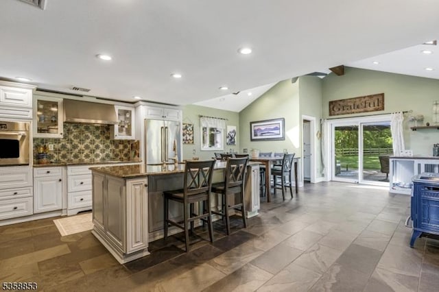 439 Mountain View Rd, Franklin Twp, NJ 08802 - kitchen featuring stainless steel appliances, a kitchen bar, wall chimney exhaust hood, a center island, and glass insert cabinets