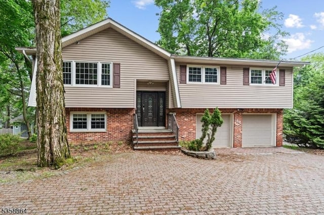 44 Stanhope Rd, Sparta Twp, NJ 07871 - bi-level home featuring decorative driveway, a garage, and brick siding