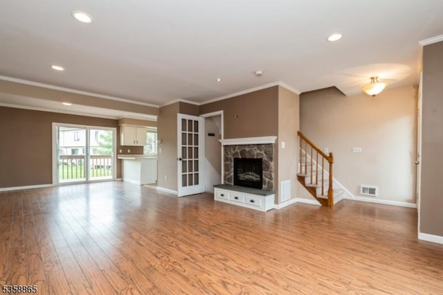 182 Dakota Dr, Andover Twp, NJ 07848 - unfurnished living room with crown molding, wood finished floors, baseboards, stairway, and a fireplace