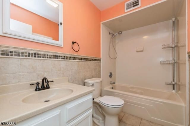 182 Dakota Dr, Andover Twp, NJ 07848 - bathroom featuring toilet, vanity, shower / tub combination, tile patterned floors, and tile walls