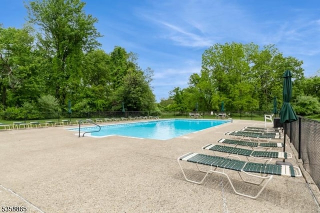 182 Dakota Dr, Andover Twp, NJ 07848 - community pool with a patio area and view of wooded area