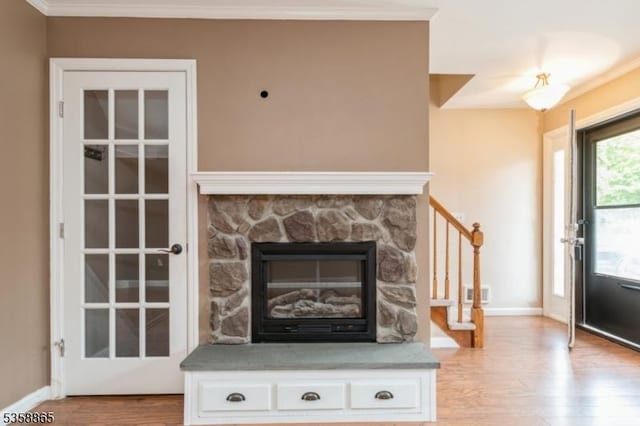 182 Dakota Dr, Andover Twp, NJ 07848 - detailed view of wood finished floors, baseboards, ornamental molding, and a stone fireplace