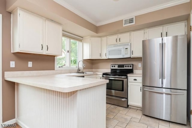 182 Dakota Dr, Andover Twp, NJ 07848 - kitchen with appliances with stainless steel finishes, a peninsula, light countertops, a sink, and ornamental molding