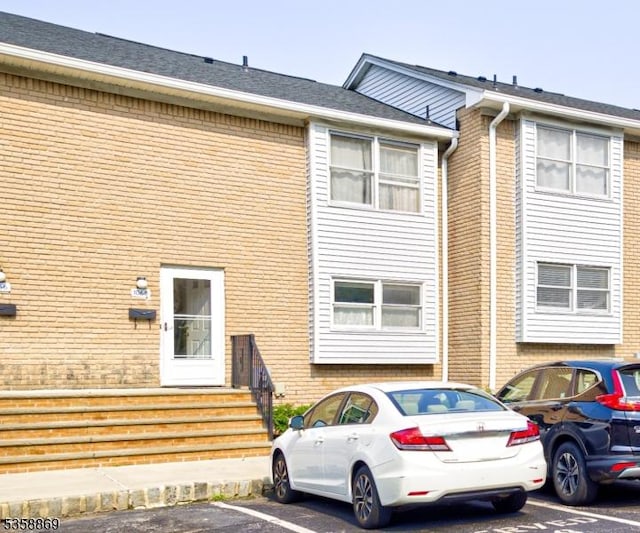 1068 Robin Rd, Hillsborough Twp, NJ 08844 - view of property with brick siding and uncovered parking