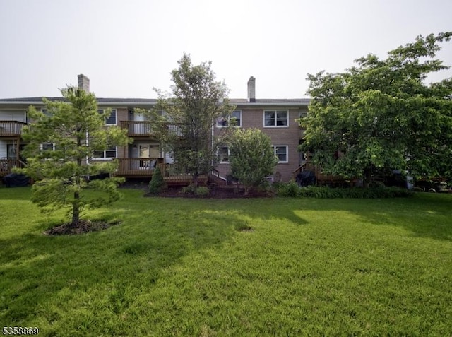 1068 Robin Rd, Hillsborough Twp, NJ 08844 - view of grassy yard featuring a wooden deck and a balcony