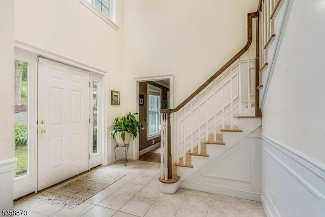 221 Sussex Ave, Andover Twp, NJ 07860 - entryway with stairs, light tile patterned flooring, a towering ceiling, and wainscoting