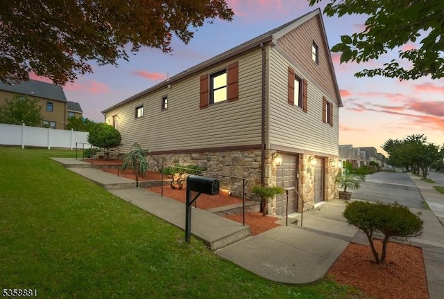 74-76 Watsessing Ave, Belleville Twp, NJ 07109 - property exterior at dusk featuring a garage, stone siding, and concrete driveway