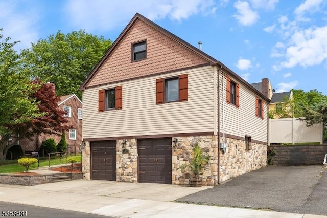 74-76 Watsessing Ave, Belleville Twp, NJ 07109 - view of home's exterior with stone siding, concrete driveway, and a garage