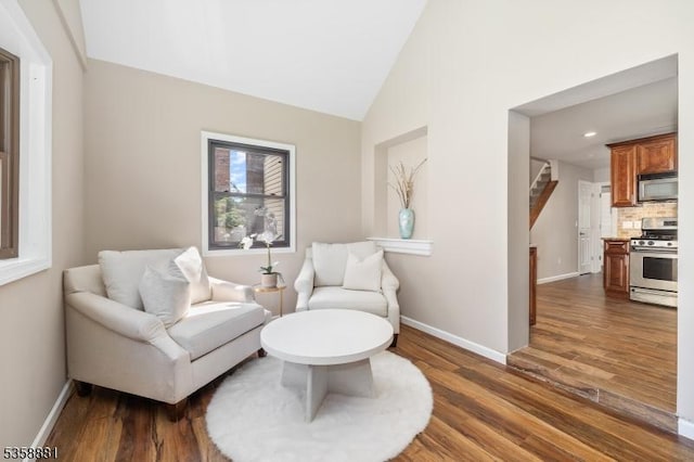 74-76 Watsessing Ave, Belleville Twp, NJ 07109 - living area featuring wood finished floors, baseboards, stairway, and high vaulted ceiling