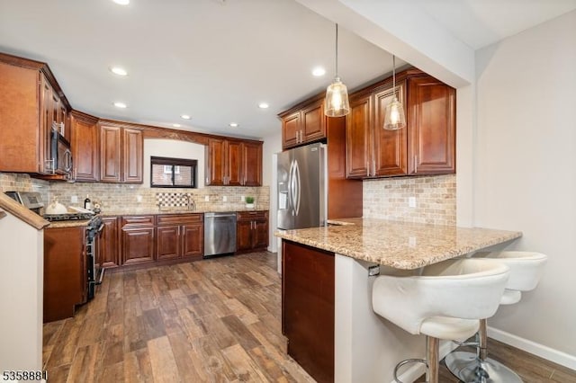 74-76 Watsessing Ave, Belleville Twp, NJ 07109 - kitchen with appliances with stainless steel finishes, a peninsula, dark wood finished floors, a breakfast bar area, and recessed lighting