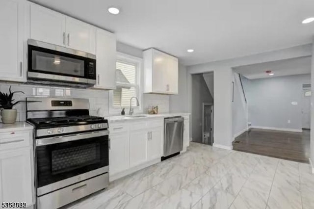 39 Emma St, Plainfield City, NJ 07063 - kitchen featuring appliances with stainless steel finishes, light countertops, a sink, white cabinetry, and recessed lighting