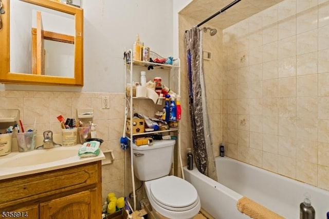 bathroom with toilet, shower / tub combo with curtain, tile walls, and vanity