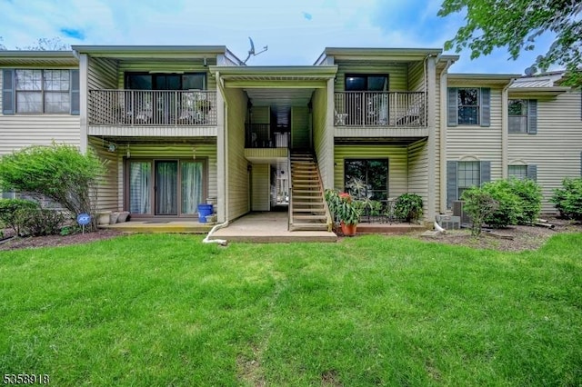 62 Taylor Dr, Franklin Twp, NJ 08823 - back of property with stairway, a yard, and a balcony