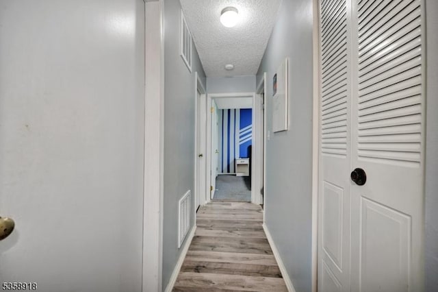 62 Taylor Dr, Franklin Twp, NJ 08823 - hall with a textured ceiling and light wood-style flooring