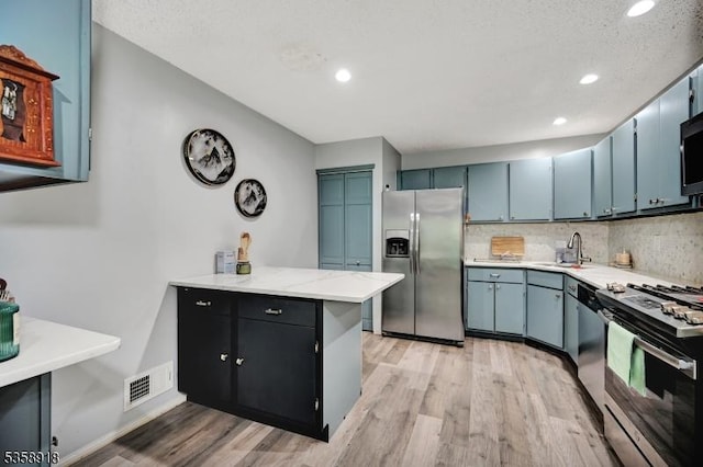 62 Taylor Dr, Franklin Twp, NJ 08823 - kitchen featuring stainless steel appliances, light wood-style flooring, a peninsula, recessed lighting, and decorative backsplash