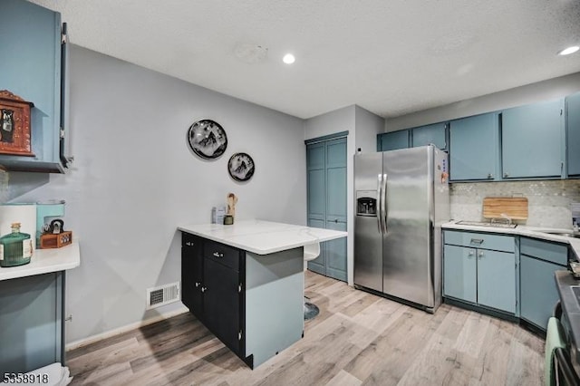 62 Taylor Dr, Franklin Twp, NJ 08823 - kitchen with stainless steel fridge with ice dispenser, light wood-type flooring, backsplash, blue cabinets, and recessed lighting