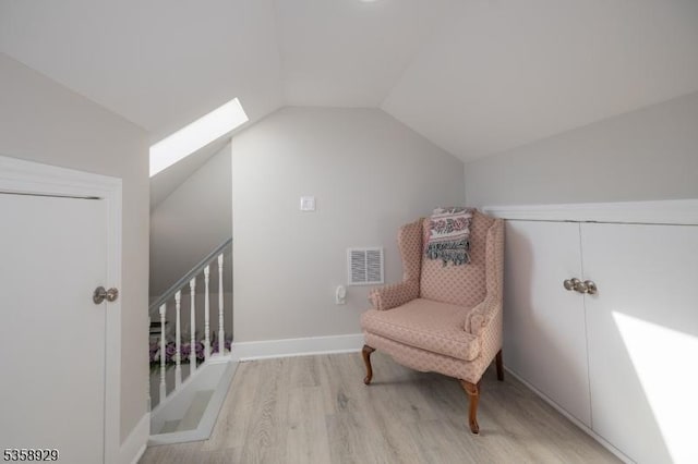 118 Holly St, Woodbridge Twp, NJ 07064 - sitting room with wood finished floors, lofted ceiling, a skylight, and baseboards