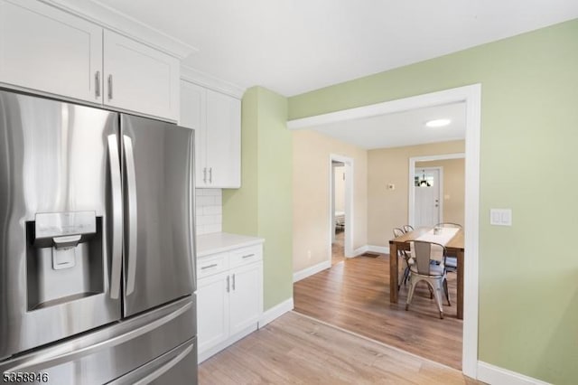 3 Raritan Ave, Roxbury Twp, NJ 07852 - kitchen featuring stainless steel fridge, white cabinets, light wood-style floors, baseboards, and light countertops
