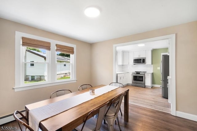 3 Raritan Ave, Roxbury Twp, NJ 07852 - dining room with baseboard heating, light wood-type flooring, and baseboards