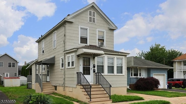 118 S 7th Ave, Manville Boro, NJ 08835 - view of front facade with entry steps and a garage