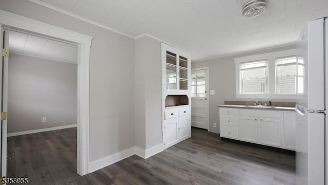 118 S 7th Ave, Manville Boro, NJ 08835 - kitchen with ornamental molding, a sink, dark wood finished floors, white cabinetry, and baseboards