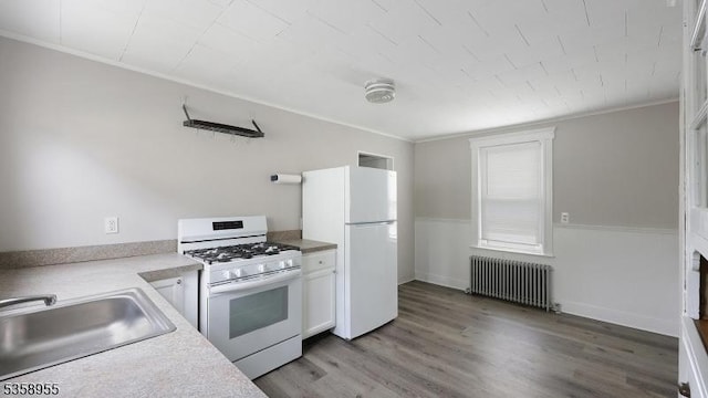 118 S 7th Ave, Manville Boro, NJ 08835 - kitchen featuring radiator, white appliances, a sink, white cabinets, and wood finished floors