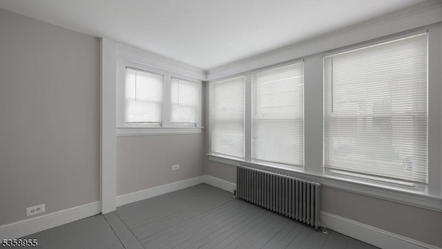 118 S 7th Ave, Manville Boro, NJ 08835 - spare room with radiator heating unit, baseboards, and tile patterned flooring