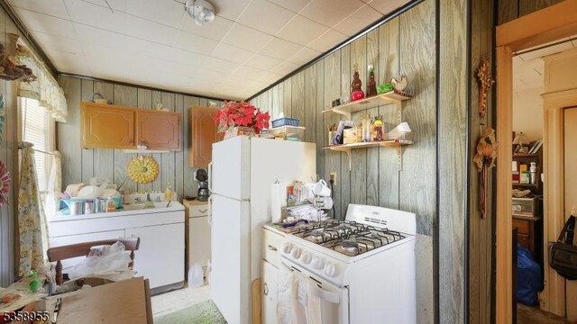118 S 7th Ave, Manville Boro, NJ 08835 - kitchen featuring white appliances, wood walls, and open shelves