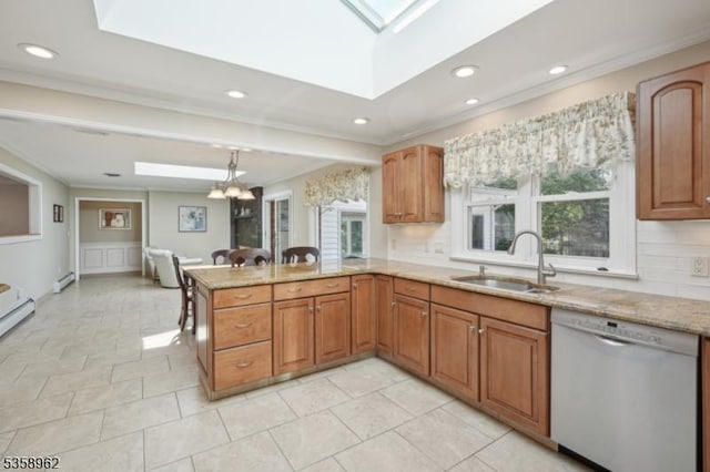 7 Dells Dr, Denville Twp, NJ 07834 - kitchen with dishwashing machine, a sink, a skylight, light stone counters, and decorative backsplash