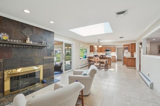 7 Dells Dr, Denville Twp, NJ 07834 - living room featuring a baseboard radiator, a tile fireplace, a skylight, ornamental molding, and recessed lighting