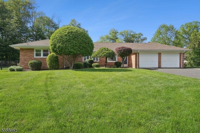 7 Dells Dr, Denville Twp, NJ 07834 - ranch-style home with asphalt driveway, an attached garage, and brick siding