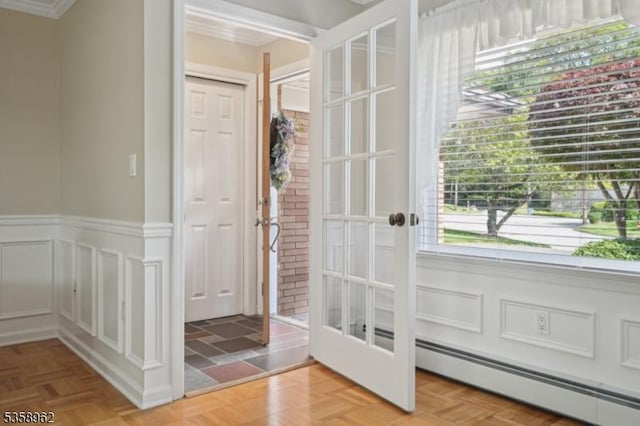 7 Dells Dr, Denville Twp, NJ 07834 - doorway to outside featuring a baseboard heating unit, crown molding, french doors, a decorative wall, and wainscoting