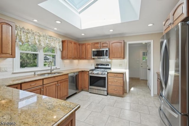 7 Dells Dr, Denville Twp, NJ 07834 - kitchen featuring stainless steel appliances, a skylight, a sink, backsplash, and crown molding