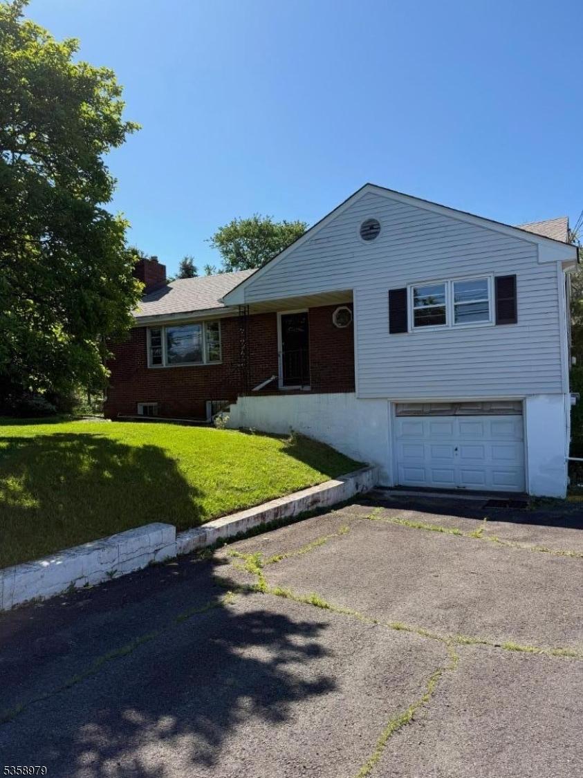 733 US Highway 202, Bridgewater Twp, NJ 08807 - ranch-style home featuring an attached garage, a chimney, a front yard, driveway, and brick siding