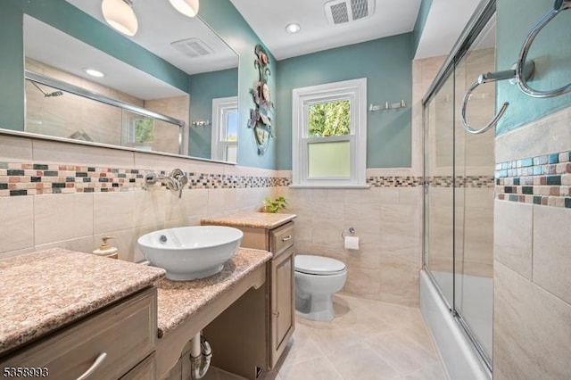110 William St, Clark Twp, NJ 07066 - full bath with tile walls, vanity, bath / shower combo with glass door, tile patterned floors, and toilet