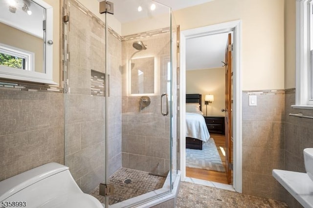 110 William St, Clark Twp, NJ 07066 - ensuite bathroom with tile walls, a stall shower, tile patterned floors, and toilet
