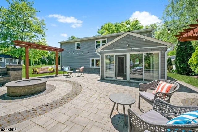 110 William St, Clark Twp, NJ 07066 - rear view of house with an outdoor fire pit, a pergola, a sunroom, and a patio