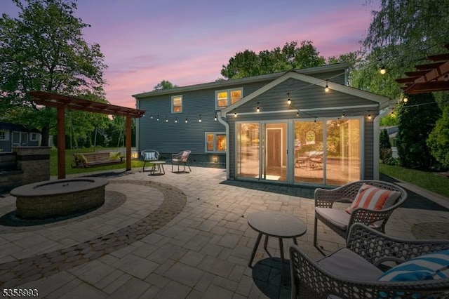 110 William St, Clark Twp, NJ 07066 - back of house at dusk with an outdoor fire pit, a patio area, a pergola, and a sunroom