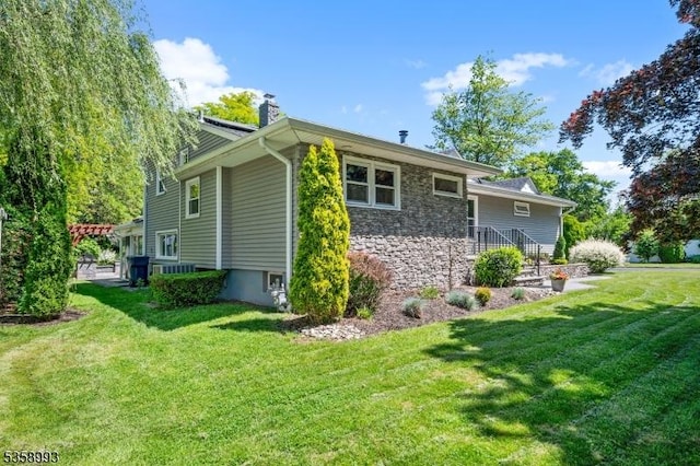 110 William St, Clark Twp, NJ 07066 - view of side of property featuring a chimney, a lawn, and stone siding