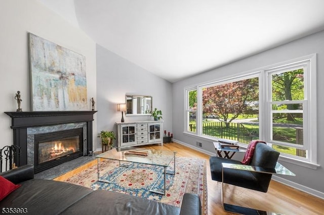 110 William St, Clark Twp, NJ 07066 - living room featuring vaulted ceiling, a high end fireplace, baseboards, and wood finished floors
